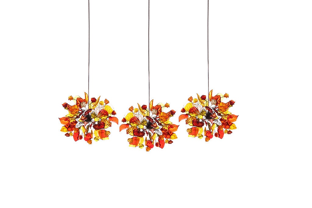 Triple pendants lights with warm color flowers and leaves for Kitchen Island.